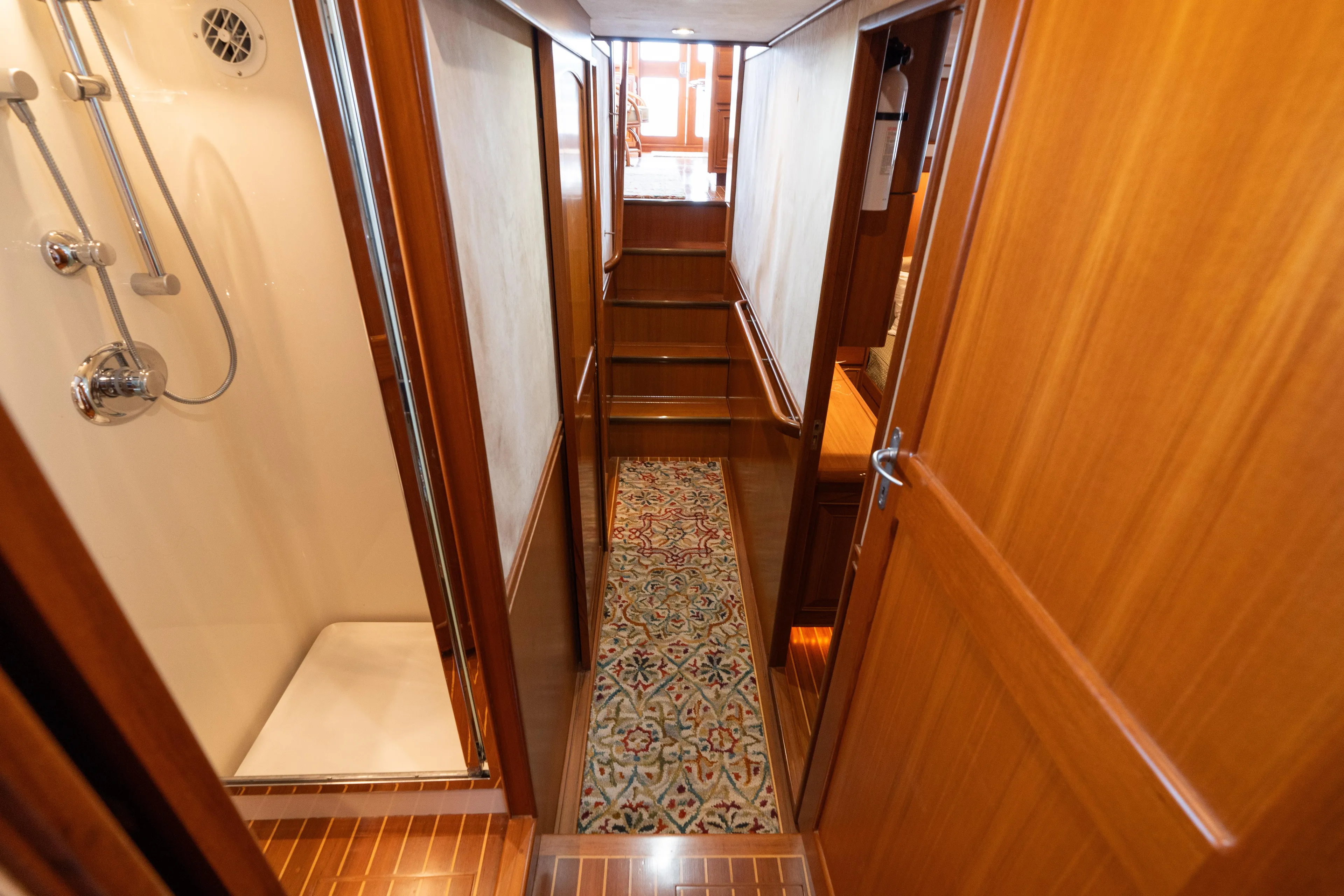 Fiddlesticks Yacht Photos Pics Luxurious wooden interior hallway of a 2007 Fleming 55 yacht with shower and carpet.