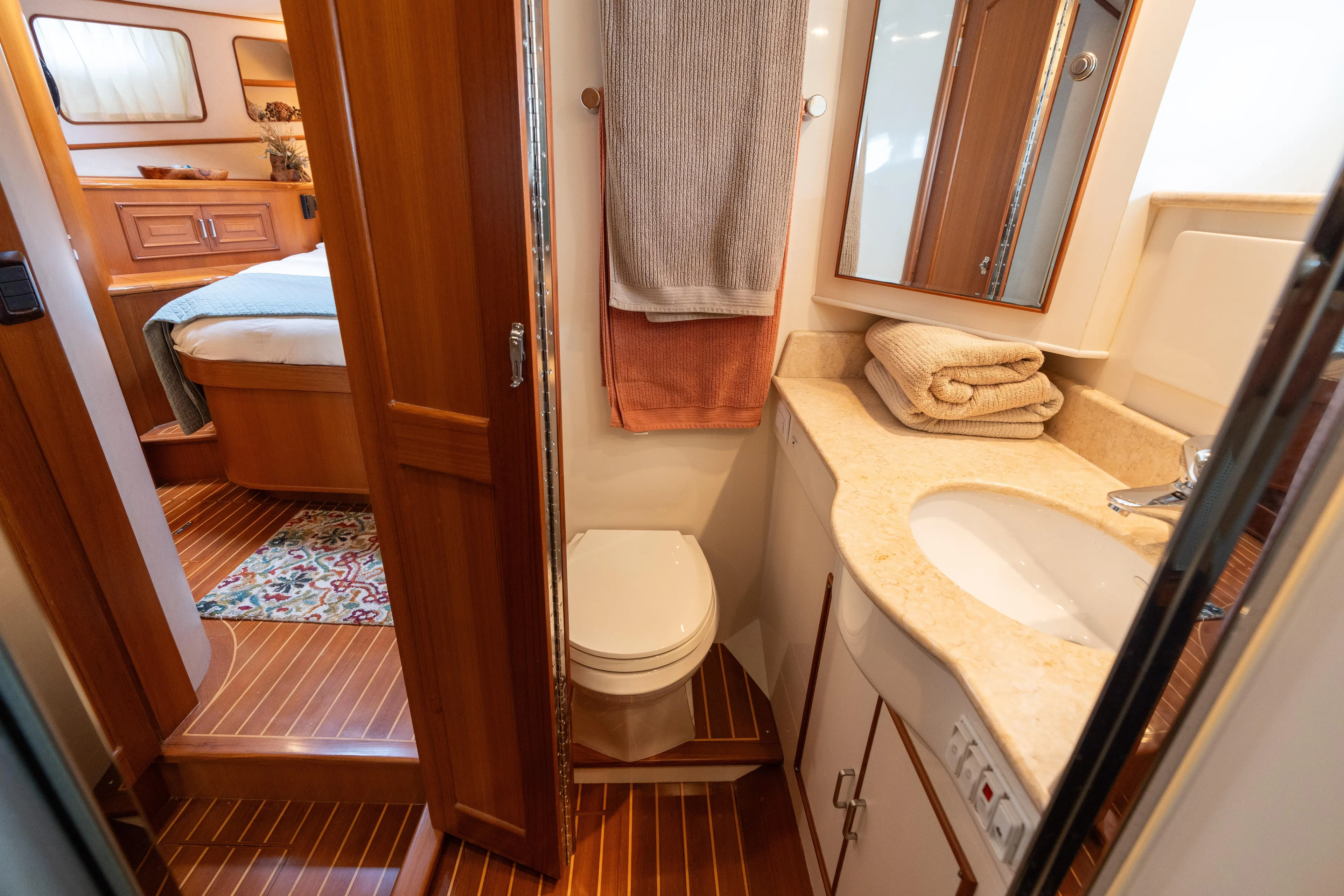 Fiddlesticks Yacht Photos Pics Luxurious 2007 Fleming 55 yacht bathroom with wood accents and cozy bedroom view.