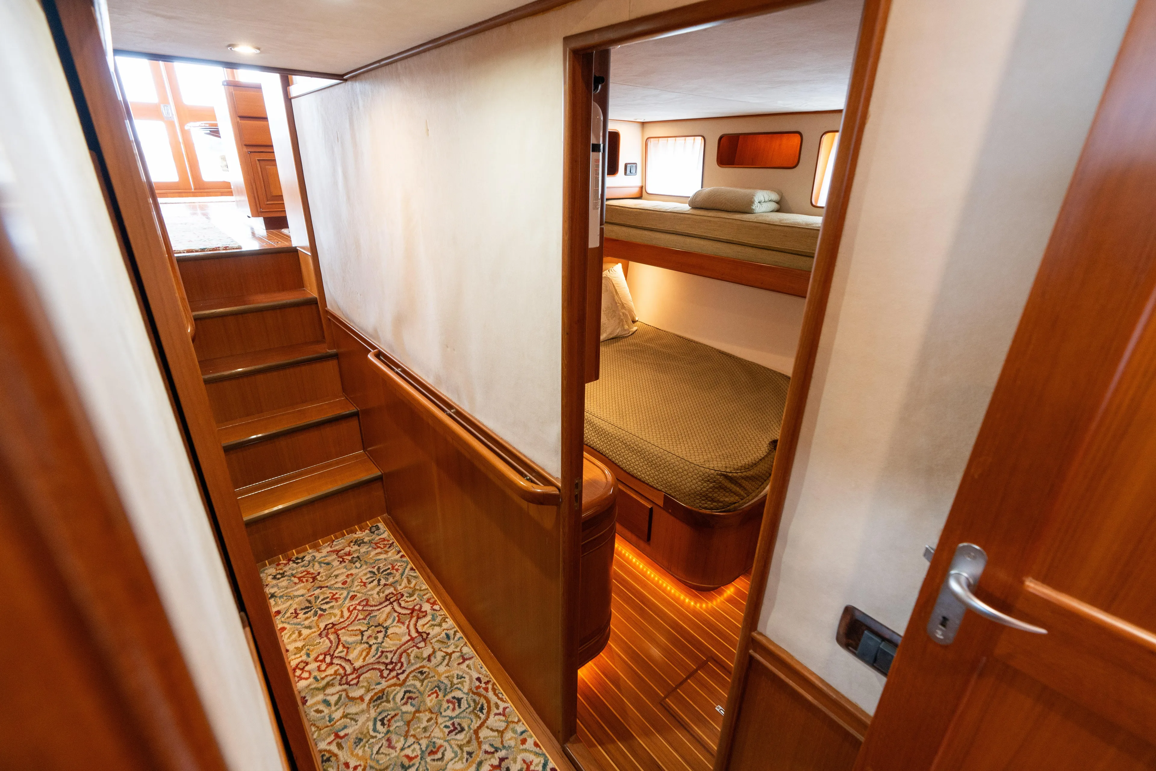 Fiddlesticks Yacht Photos Pics Interior of 2007 Fleming 55 yacht with wooden stairs and cozy cabin.