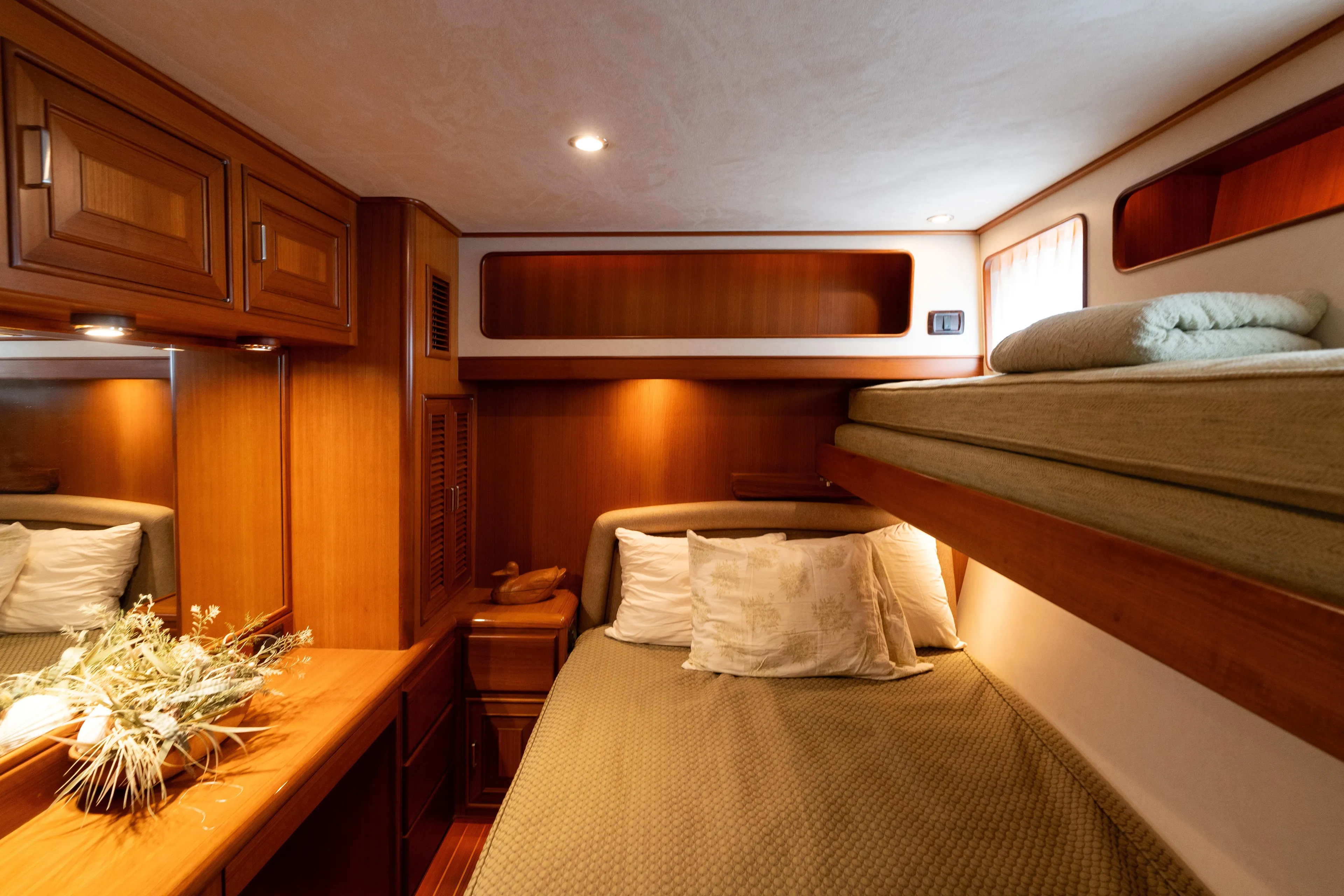 Fiddlesticks Yacht Photos Pics Luxurious 2007 Fleming 55 yacht cabin with wooden interior and cozy bedding.