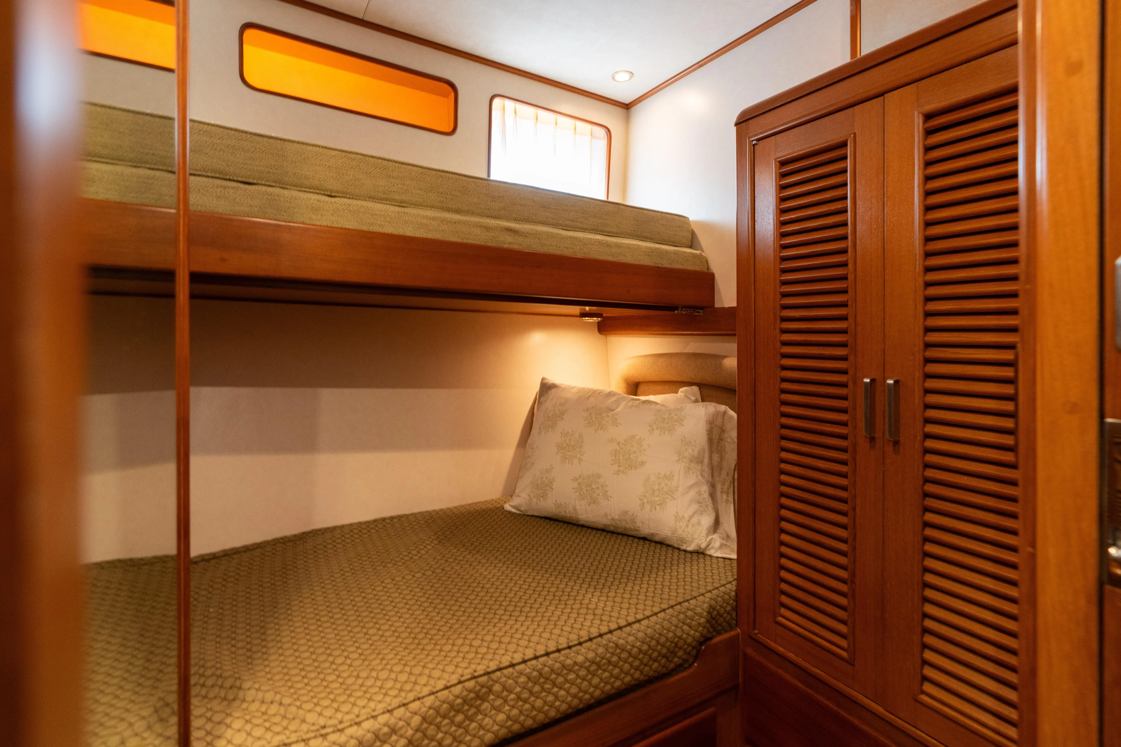 Fiddlesticks Yacht Photos Pics Cozy cabin interior of 2007 Fleming 55 yacht with bunk beds and wooden wardrobe.