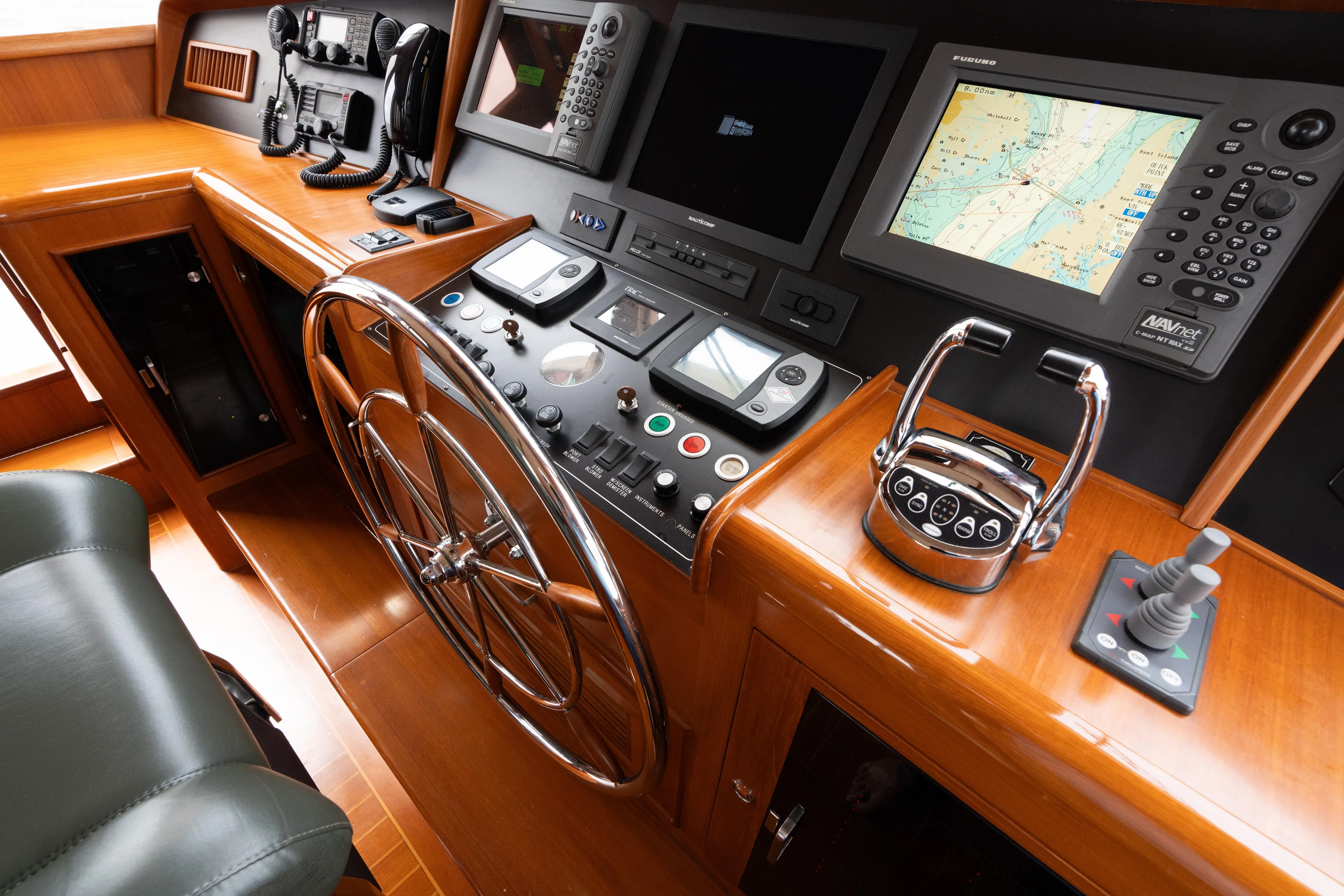 Fiddlesticks Yacht Photos Pics Control panel of a 2007 Fleming 55 yacht with navigation equipment and steering wheel.