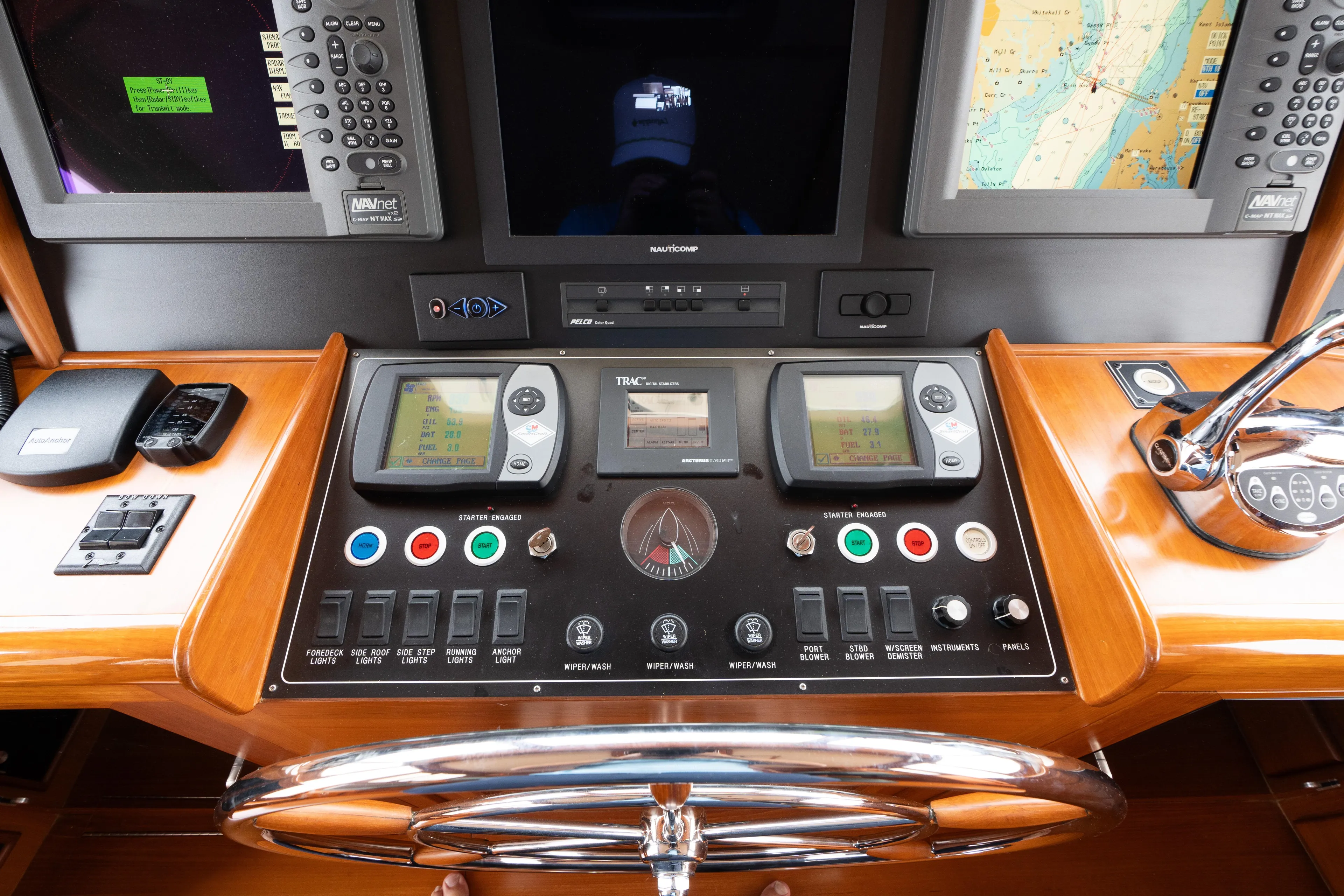 Fiddlesticks Yacht Photos Pics Control panel of a 2007 Fleming 55 yacht with navigation instruments and steering wheel.