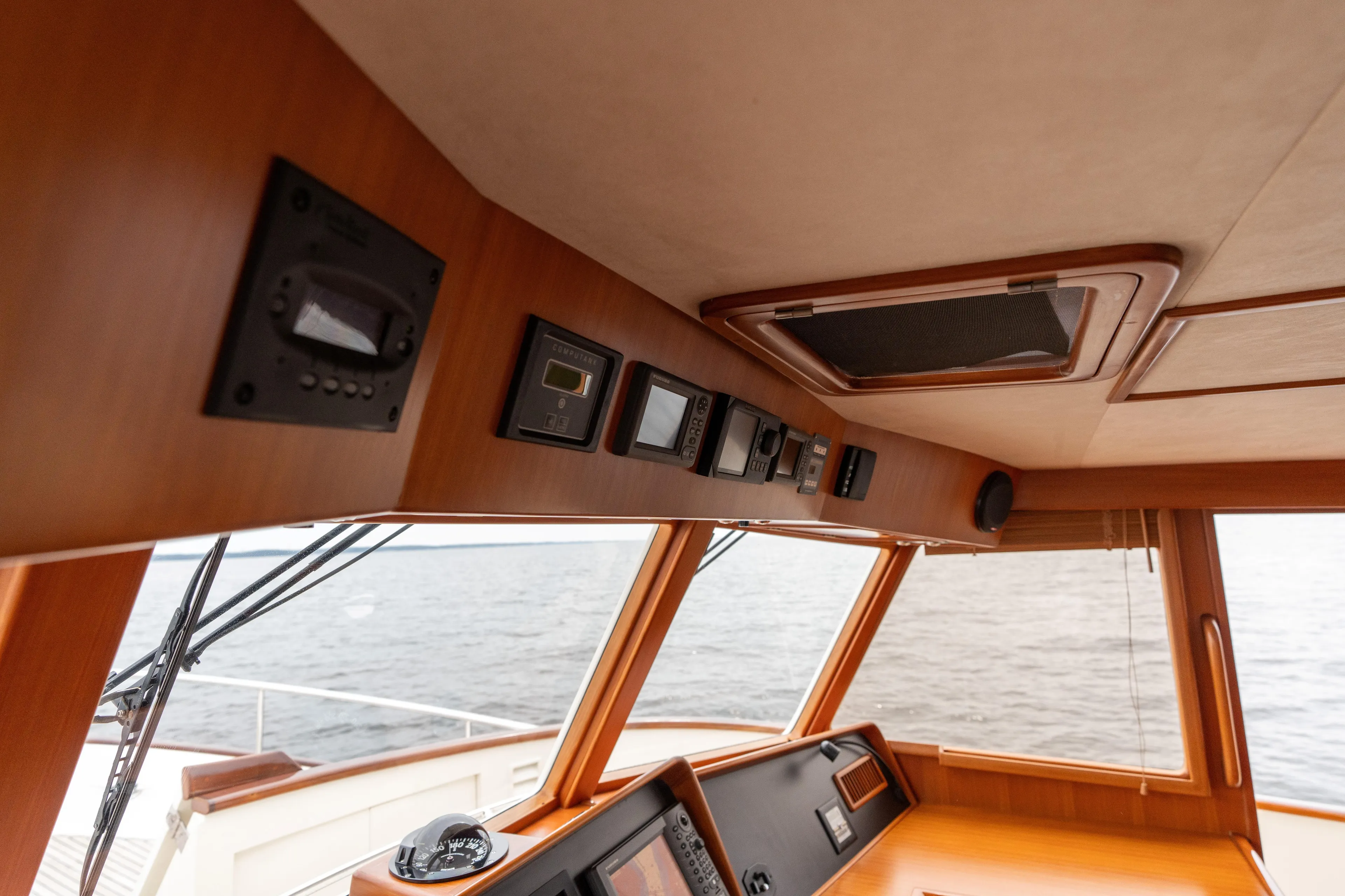 Fiddlesticks Yacht Photos Pics Interior view of 2007 Fleming 55 yacht helm with navigation instruments and sea view.