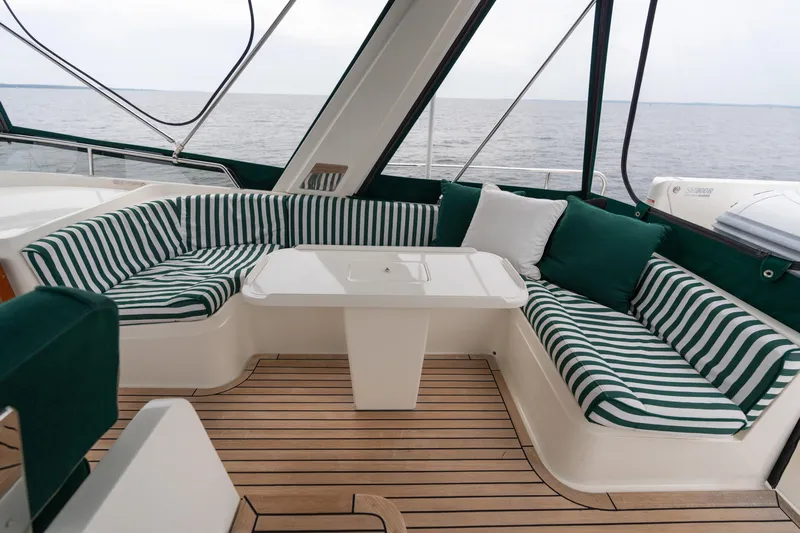 Fiddlesticks Yacht Photos Pics Luxurious 2007 Fleming 55 yacht interior with striped seating and ocean view.