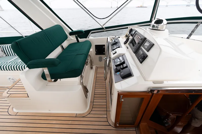 Fiddlesticks Yacht Photos Pics Luxurious 2007 Fleming 55 yacht helm with green cushioned seating and advanced navigation controls.