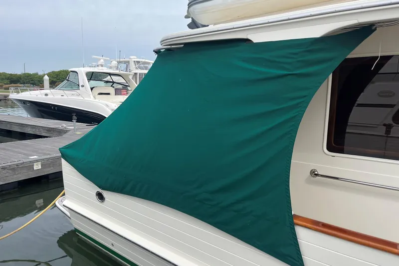 Fiddlesticks Yacht Photos Pics 2007 Fleming 55 yacht with green sunshade docked at marina.