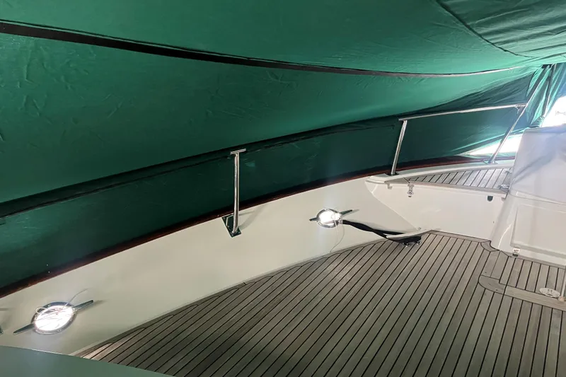 Fiddlesticks Yacht Photos Pics Covered deck area of a 2007 Fleming 55 yacht with green canopy.