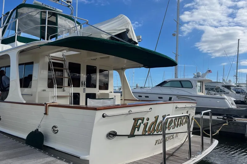 Fiddlesticks Yacht Photos Pics Luxury 2007 Fleming 55 yacht docked at marina under blue sky.