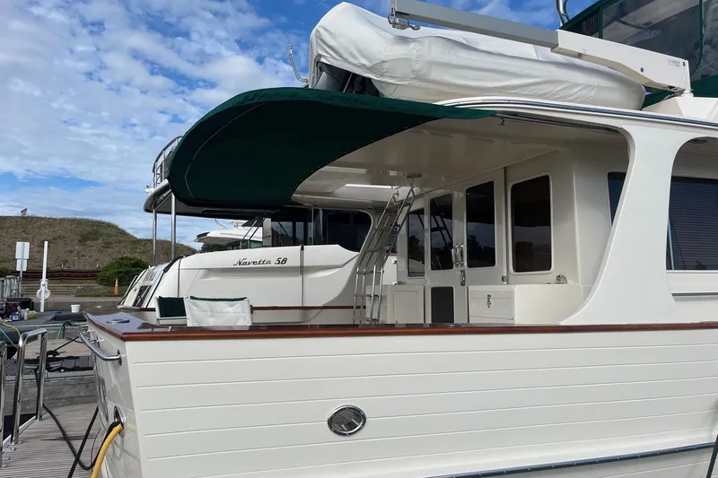Fiddlesticks Yacht Photos Pics 2007 Fleming 55 yacht docked, featuring elegant design and green canopy under a blue sky.