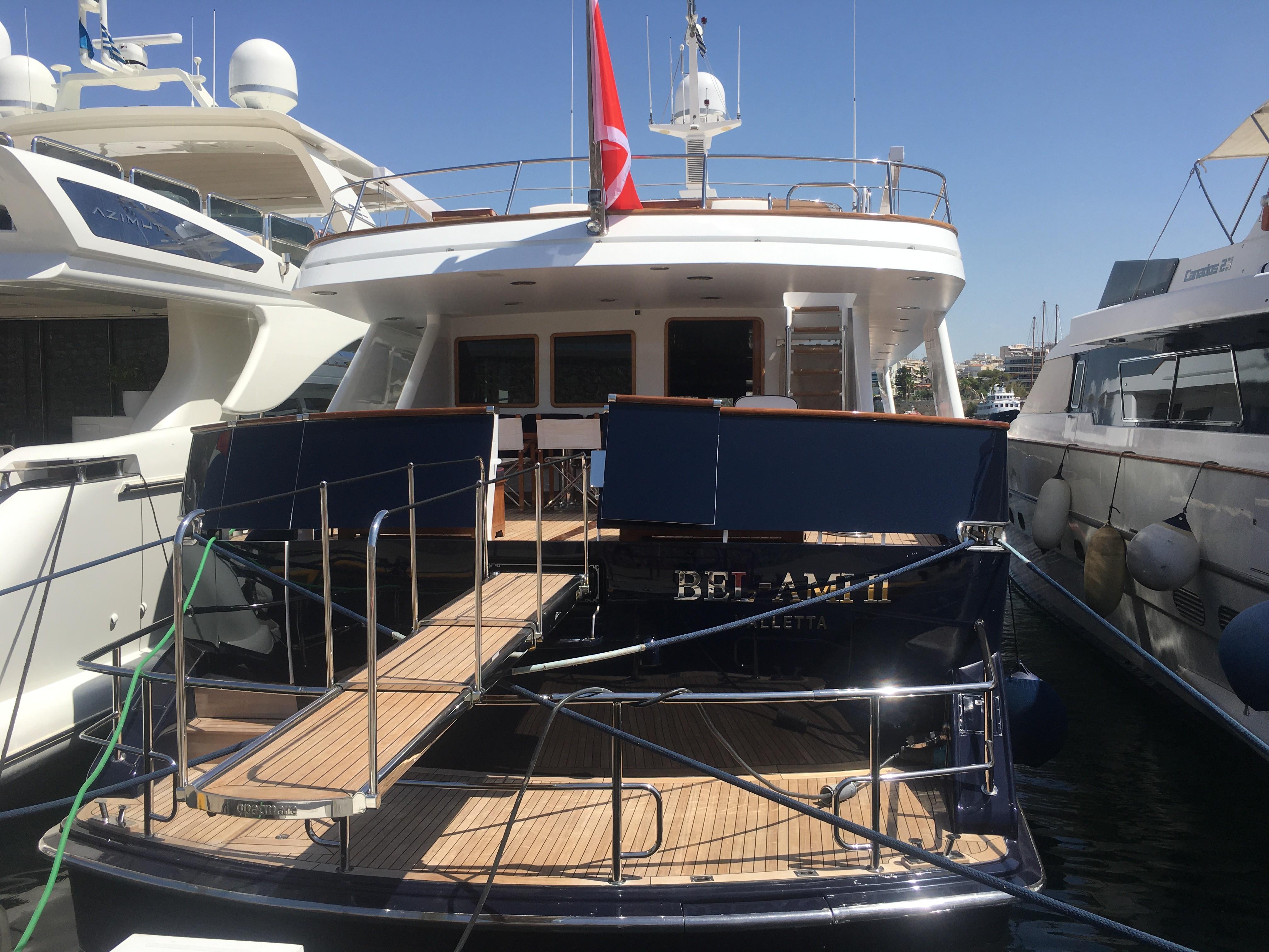 1988 Codecasa Displacement Yacht docked, featuring a spacious deck and elegant design.