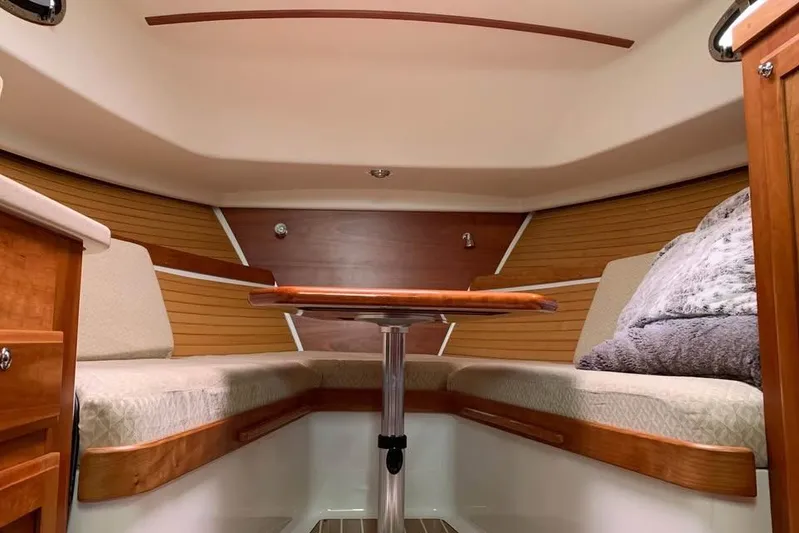  Yacht Photos Pics Interior of a 2008 Back Cove 29 boat with cozy seating and wooden table.