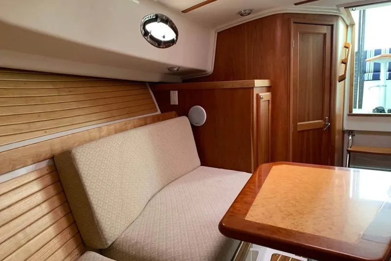  Yacht Photos Pics 2008 Back Cove 29 interior with wooden finish, cushioned seating, and a polished table.