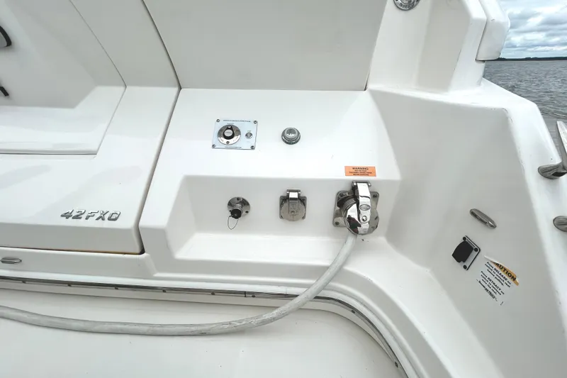 Party's Over Yacht Photos Pics 2024 Regal 42 FXO boat deck with utility connections and control panel.