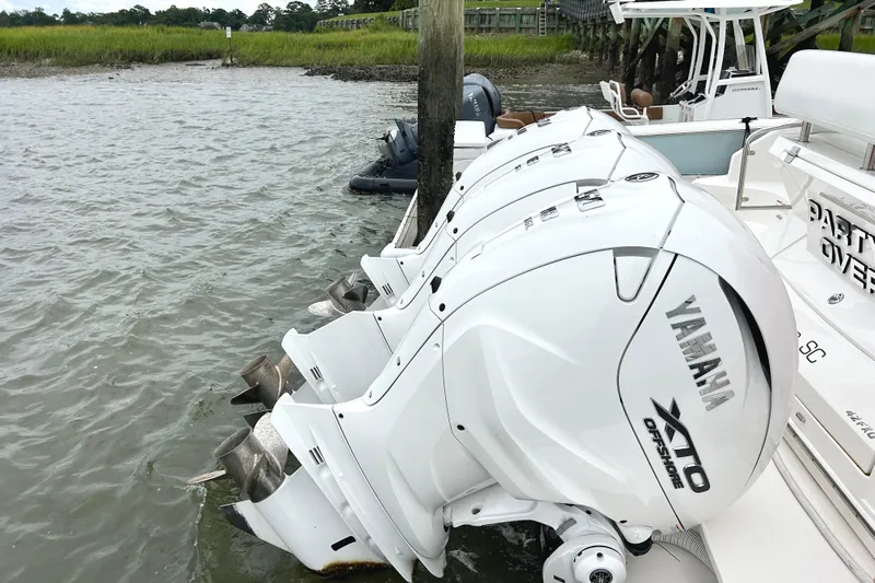 Party's Over Yacht Photos Pics 2024 Regal 42 FXO with Yamaha XTO Offshore engines docked by the water.