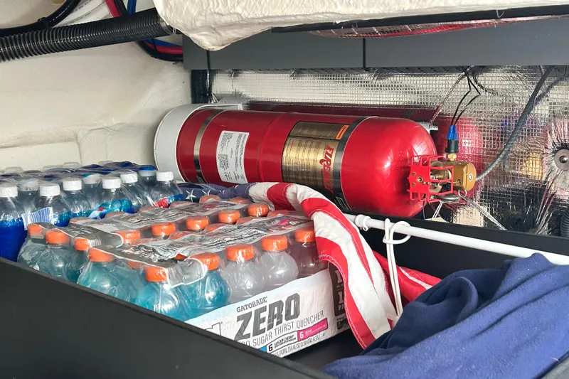Party's Over Yacht Photos Pics Storage area in 2024 Regal 42 FXO with fire extinguisher and beverages.