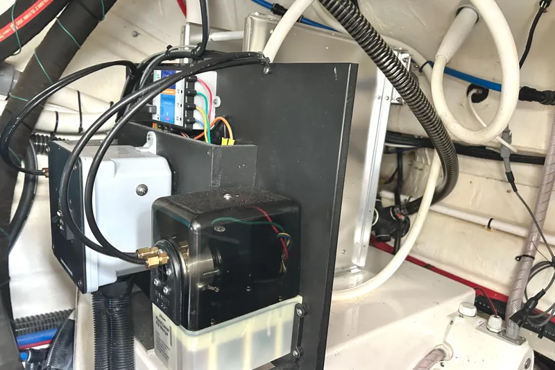 Party's Over Yacht Photos Pics Engine compartment of 2024 Regal 42 FXO boat, showcasing wiring and components.