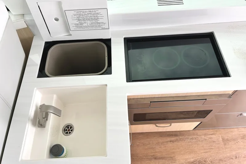 Party's Over Yacht Photos Pics 2024 Regal 42 FXO yacht kitchen with sink, stove, and storage.