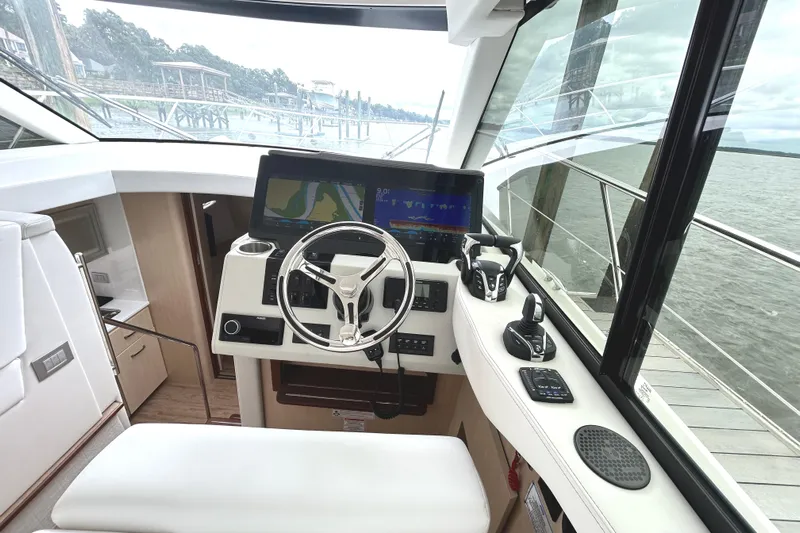 Party's Over Yacht Photos Pics 2024 Regal 42 FXO yacht helm with advanced navigation system and luxurious interior design.