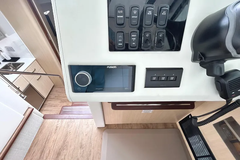 Party's Over Yacht Photos Pics Control panel of 2024 Regal 42 FXO yacht with switches and Fusion audio system.