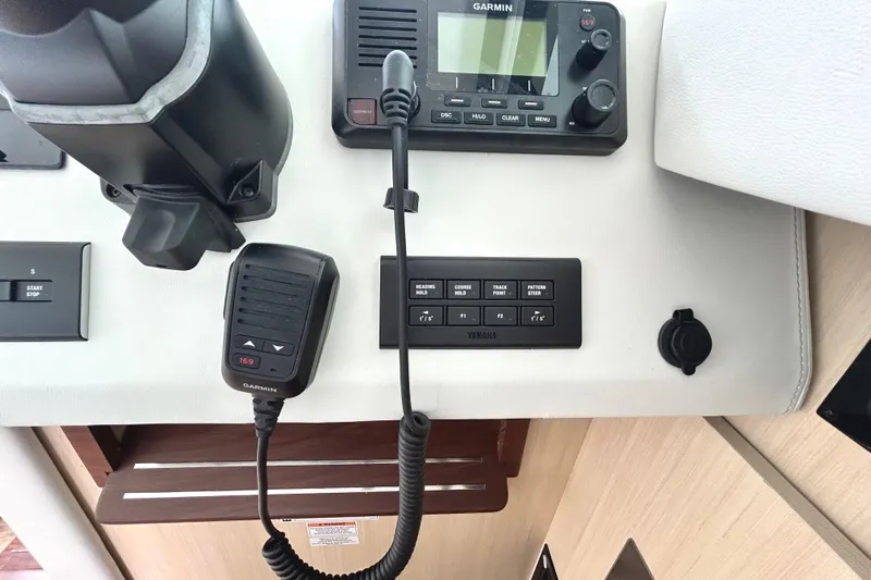 Party's Over Yacht Photos Pics Control panel of 2024 Regal 42 FXO boat with Garmin radio and Yamaha controls.