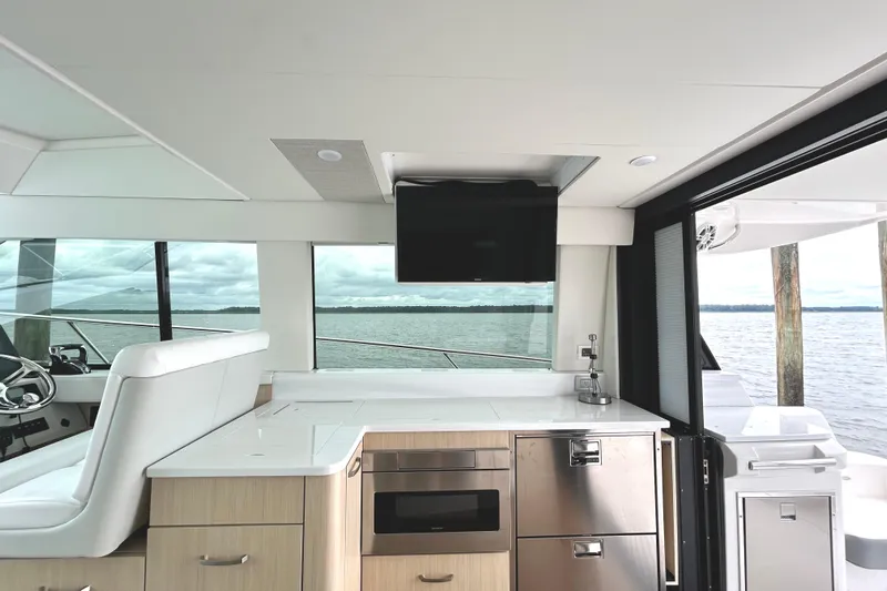 Party's Over Yacht Photos Pics Interior of 2024 Regal 42 FXO yacht with modern kitchen and scenic water view.