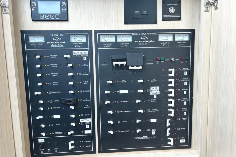 Party's Over Yacht Photos Pics Electrical control panel of 2024 Regal 42 FXO boat with various switches and meters.