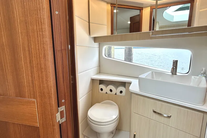 Party's Over Yacht Photos Pics Luxurious bathroom interior of 2024 Regal 42 FXO yacht with modern fixtures and ocean view.