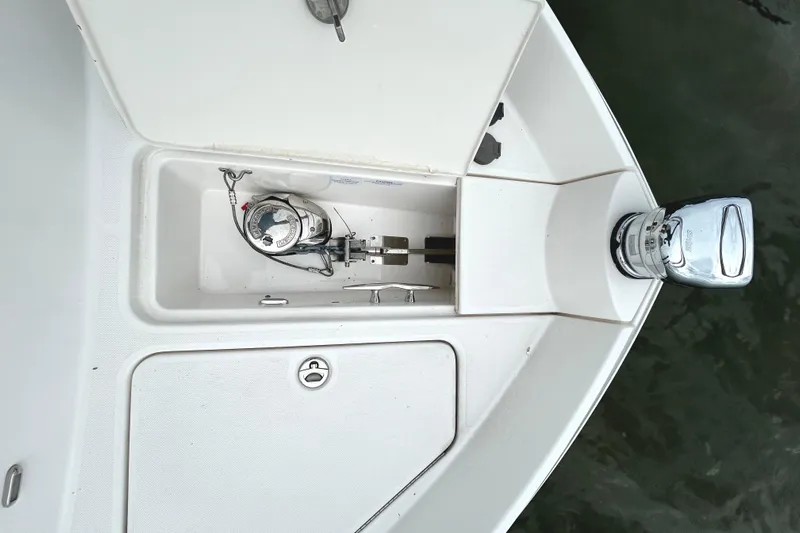Party's Over Yacht Photos Pics 2024 Regal 42 FXO boat anchor compartment with open hatch, showcasing anchor mechanism.