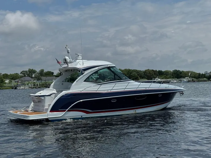  Yacht Photos Pics 2013 Formula 45 Yacht cruising on a calm lake under a cloudy sky.