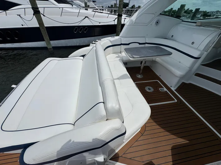  Yacht Photos Pics 2013 Formula 45 Yacht with white seating and wooden deck, docked at marina.
