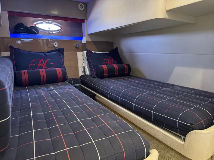  Yacht Photos Pics Interior cabin of 2013 Formula 45 Yacht with twin beds and nautical-themed bedding.