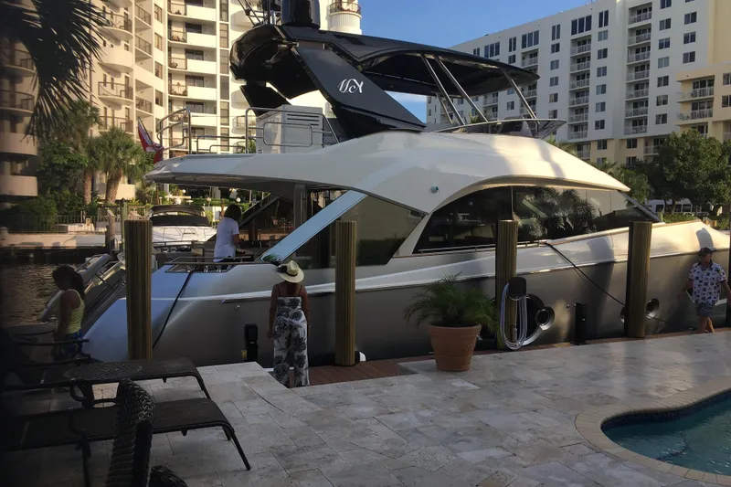  Yacht Photos Pics Monte Carlo Yachts MCY 66, 2020 model, docked near luxury apartments.