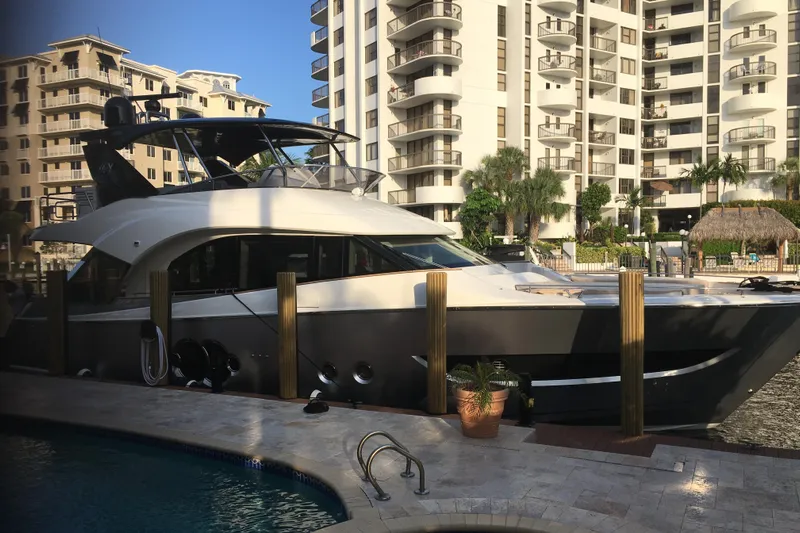  Yacht Photos Pics 2020 Monte Carlo Yachts MCY 66 docked near luxury apartments.