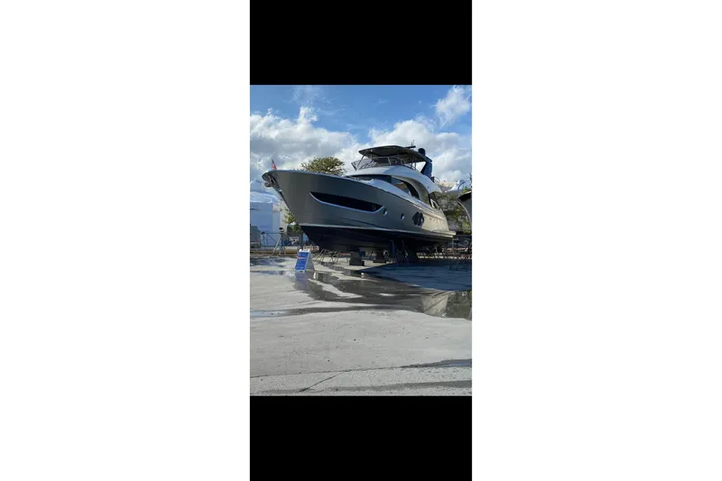  Yacht Photos Pics 2020 Monte Carlo Yachts MCY 66 on dry dock under a clear blue sky.
