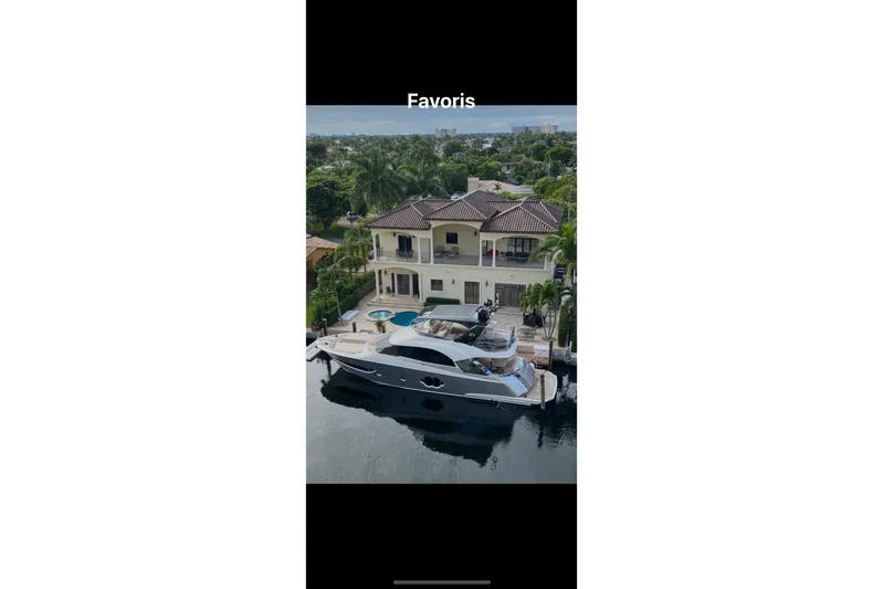  Yacht Photos Pics Luxury Monte Carlo Yachts MCY 66, 2020 model, docked by a waterfront villa.