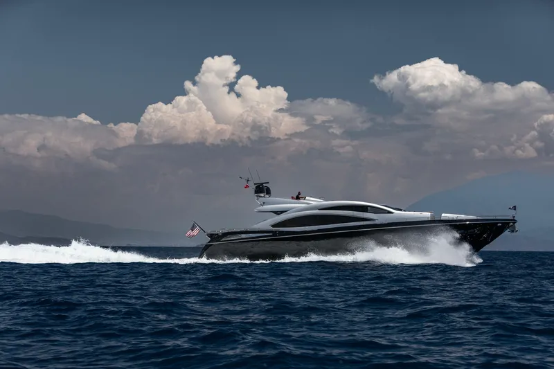  Yacht Photos Pics Luxurious 2009 Sunseeker Predator 84 yacht cruising on open sea under dramatic clouds.