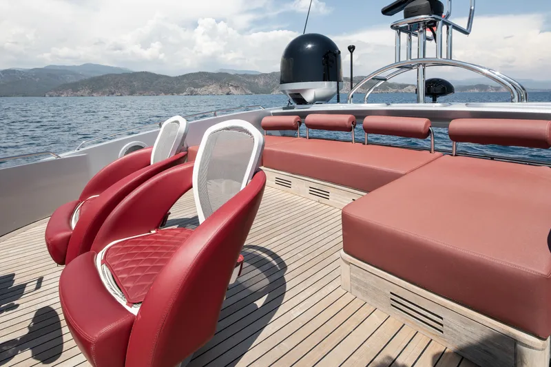  Yacht Photos Pics Luxurious 2009 Sunseeker Predator 84 yacht deck with red seating and ocean view.