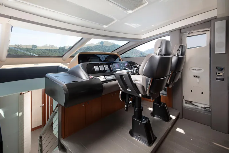  Yacht Photos Pics Interior helm of 2009 Sunseeker Predator 84 yacht with modern controls and seating.