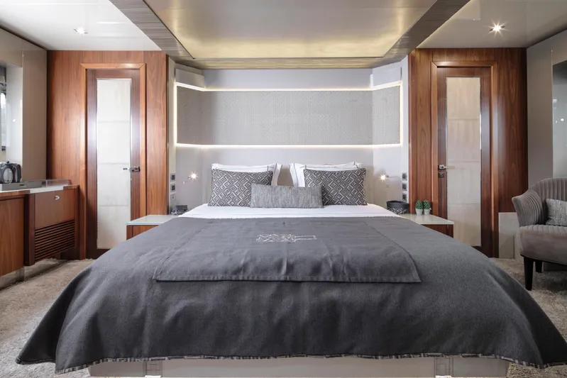  Yacht Photos Pics Luxurious bedroom interior on a 2009 Sunseeker Predator 84 yacht, featuring elegant wood finishes.