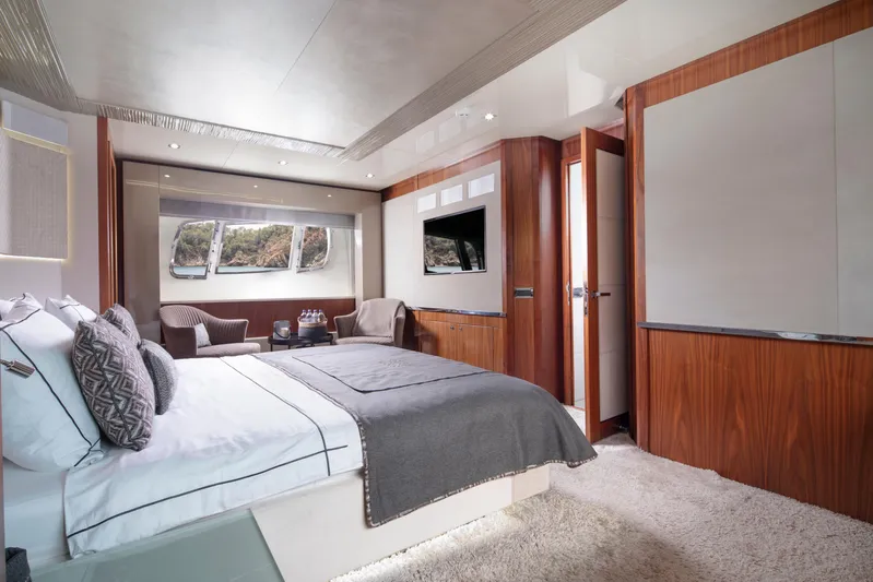  Yacht Photos Pics Luxurious bedroom interior of 2009 Sunseeker Predator 84 yacht with elegant furnishings.