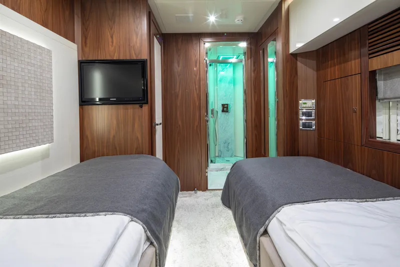  Yacht Photos Pics Luxurious twin bedroom on 2009 Sunseeker Predator 84 yacht with modern decor and ensuite bathroom.