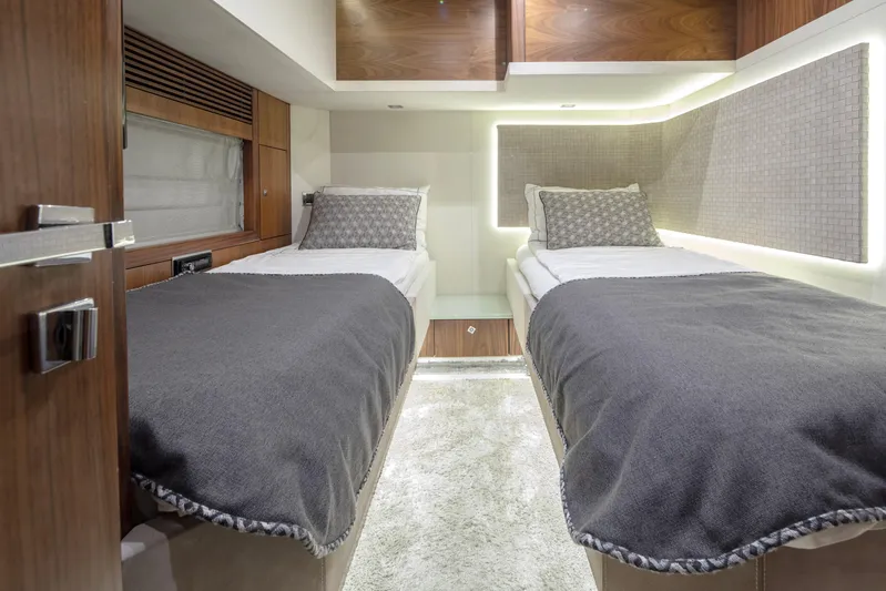  Yacht Photos Pics Luxurious twin cabin interior on 2009 Sunseeker Predator 84 yacht, featuring modern design and cozy bedding.