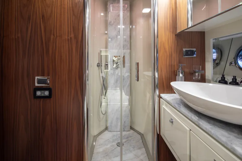  Yacht Photos Pics Luxurious bathroom on 2009 Sunseeker Predator 84 yacht with modern fixtures and wood accents.