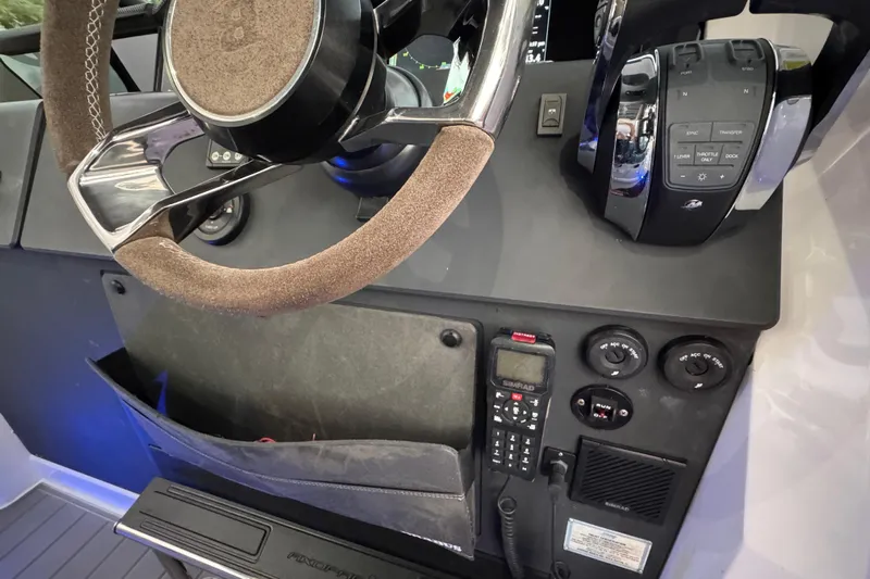  Yacht Photos Pics Steering console of 2021 Axopar 37 boat with controls and communication devices.