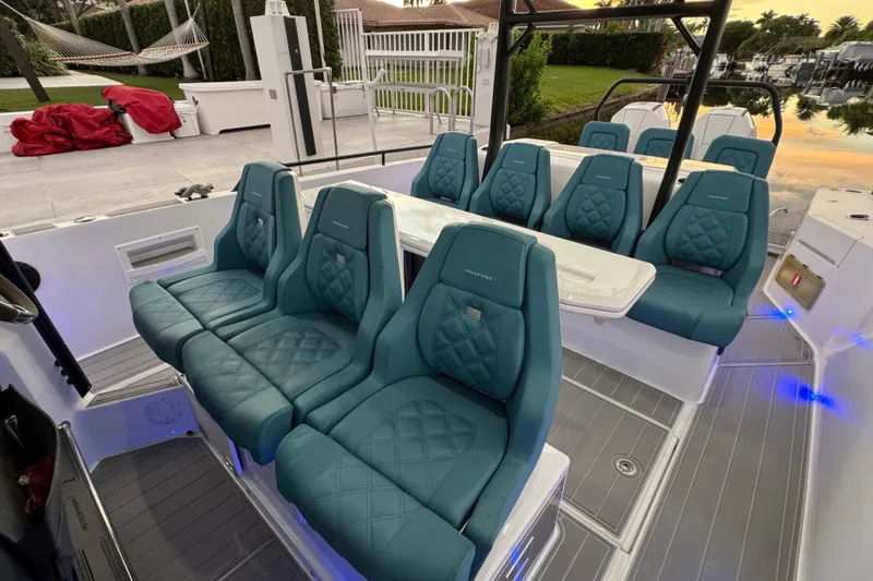 Yacht Photos Pics Luxurious seating on 2021 Axopar 37 boat with teal upholstery and modern design.