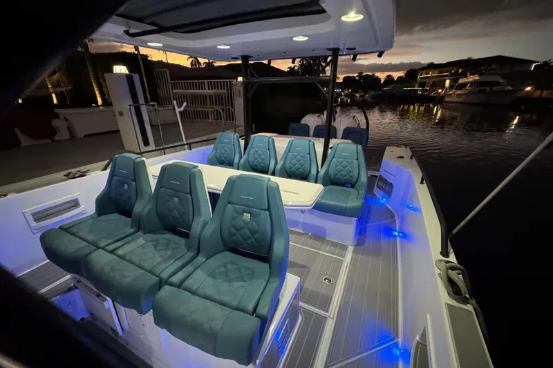  Yacht Photos Pics Luxurious 2021 Axopar 37 boat interior with elegant seating and ambient lighting at dusk.