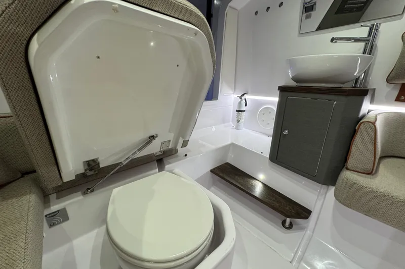  Yacht Photos Pics 2021 Axopar 37 boat interior bathroom with toilet, sink, and modern design.