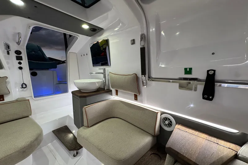  Yacht Photos Pics Luxurious interior of 2021 Axopar 37 boat with modern seating and sink.