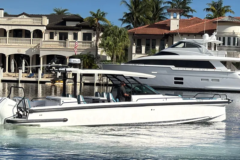  Yacht Photos Pics 2021 Axopar 37 Sun Top boat cruising near luxury waterfront homes.